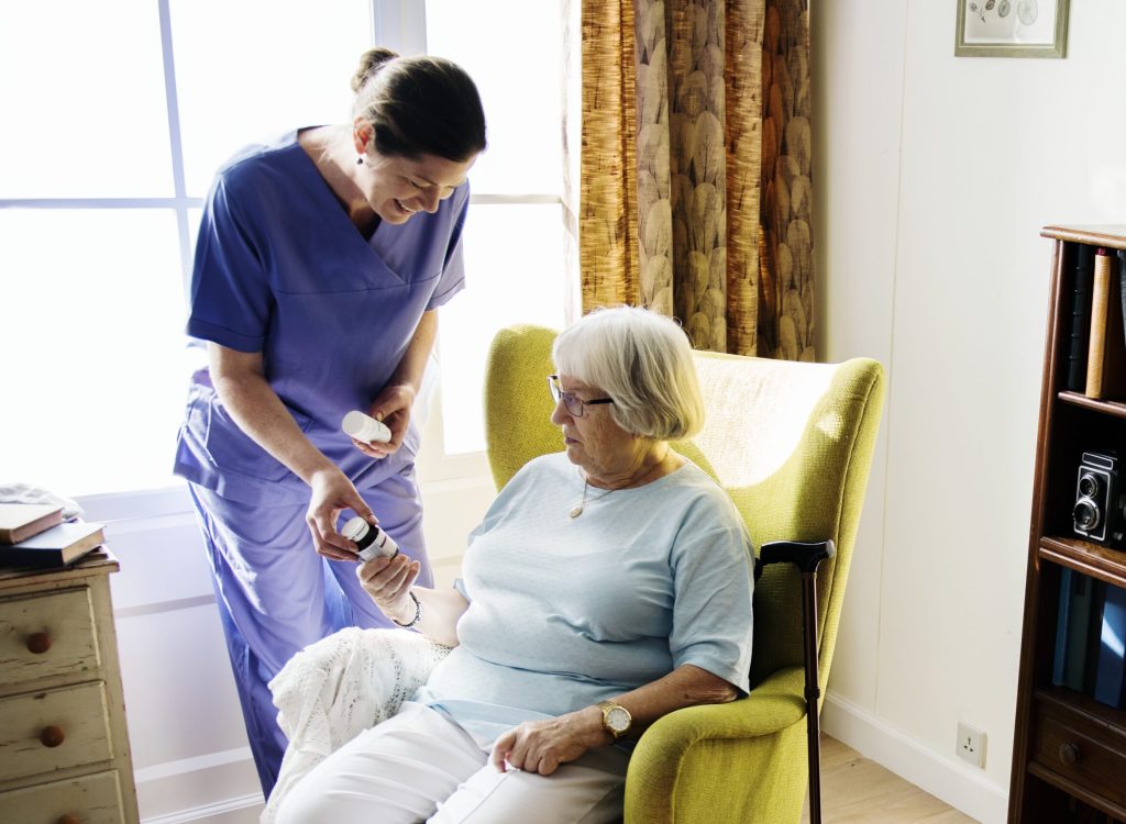 Nurse taking care of a senior woman Nurse taking care of a senior woman